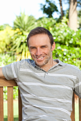 Portrait of a man sitting on a  bench