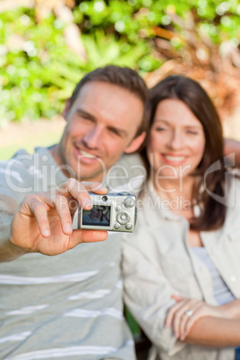 Lovers taking a photo of themselves in the garden