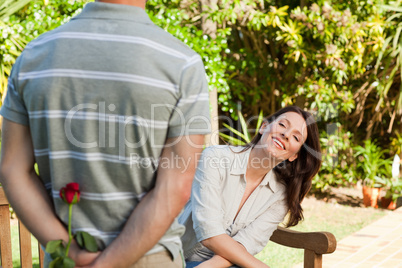 Man offering a rose to his wife