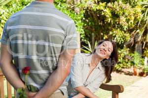 Man offering a rose to his wife