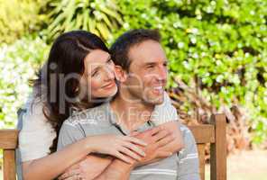 Glad couple hugging in the garden