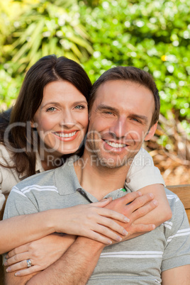 Glad couple hugging in the garden