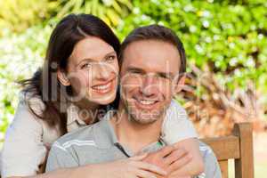 Glad couple hugging in the garden