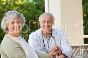 Senior doctor talking with his mature patient