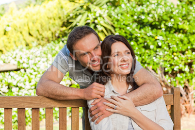 Joyful couple hugging in the garden