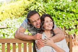 Joyful couple hugging in the garden