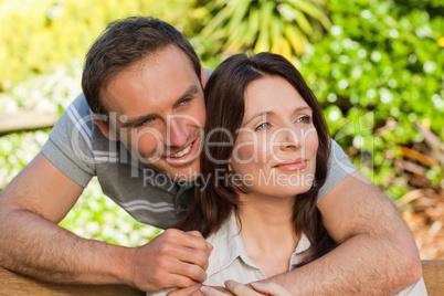 Joyful couple hugging in the garden