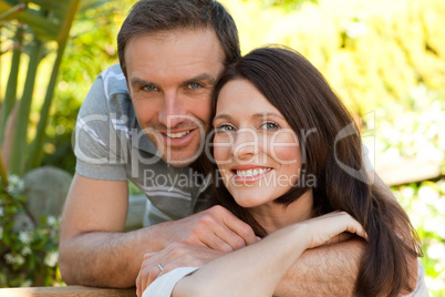 Joyful couple hugging in the garden