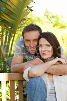 Joyful couple hugging in the garden