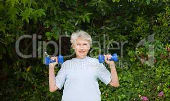 Mature woman doing her exercises in the garden