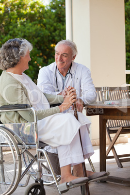 Senior doctor talking with his mature patient