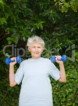 Mature woman doing her exercises in the garden