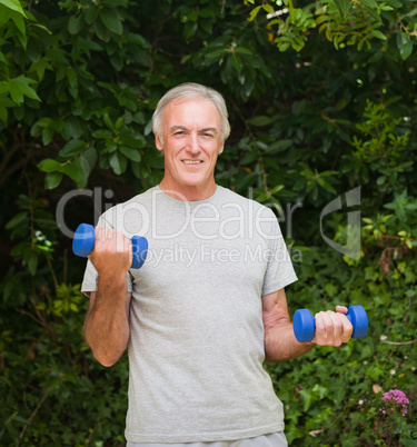 Senior man doing his exercises in the garden