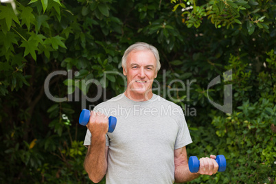 Senior man doing his exercises in the garden