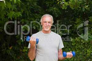 Senior man doing his exercises in the garden