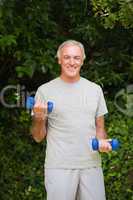 Senior man doing his exercises in the garden