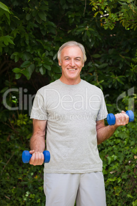 Senior man doing his exercises in the garden