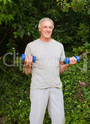 Senior man doing his exercises in the garden