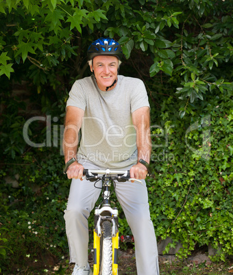 Mature man mountain biking outside