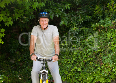 Mature man mountain biking outside