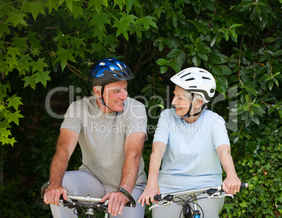 Senior couple mountain biking outside