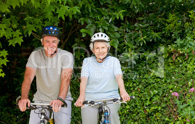 Senior couple mountain biking outside