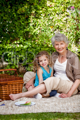 Grandmother with her granddaughter in the garden