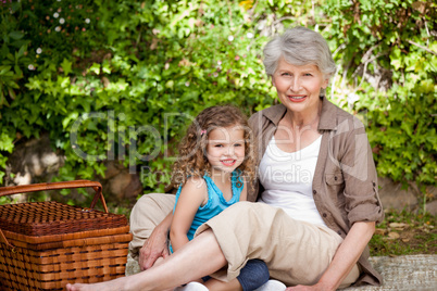 Grandmother with her granddaughter in the garden