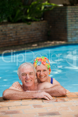 Happy mature couple in the swimming pool