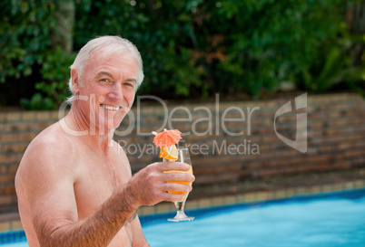 Senior man in his swimming pool