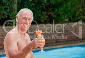 Senior man in his swimming pool