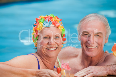 Happy mature couple in the swimming pool