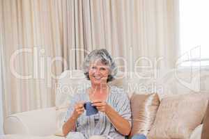 Retired woman knitting at home