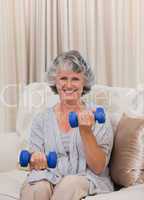 Woman doing her exercises on her sofa