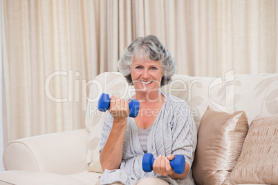 Woman doing her exercises on her sofa