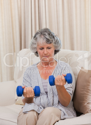 Woman doing her exercises on her sofa