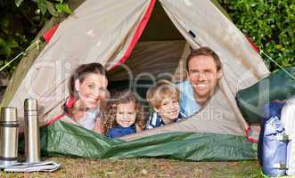 Joyful family camping in the garden