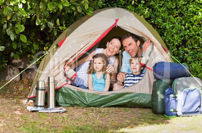 Joyful family camping in the garden