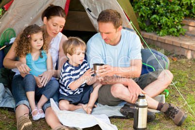 Adorable family camping in the garden