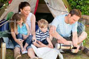 Adorable family camping in the garden