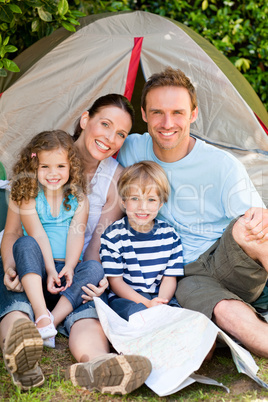 Adorable family camping in the garden