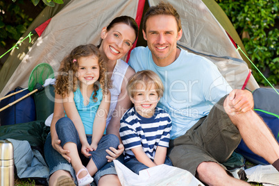 Adorable family camping in the garden