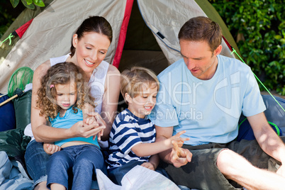 Adorable family camping in the garden