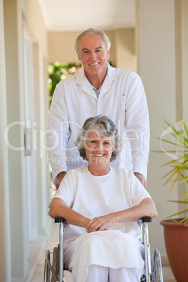 Doctor with his patient in her wheelchair