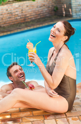 Smiling couple drinking cocktails