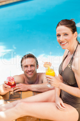 Smiling couple drinking cocktails