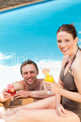 Smiling couple drinking cocktails