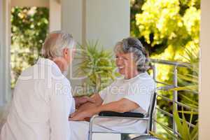 Doctor with his patient in her wheelchair