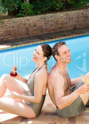 Couple drinking cocktails back to back