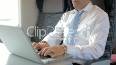 Manager working with pc on train